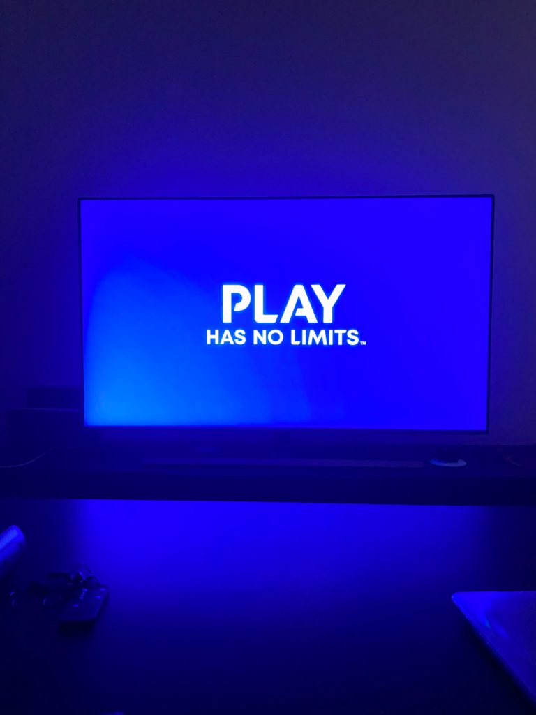 The Art and Science of Game Design: Crafting Virtual Worlds. Photo of a blue room, on a huge screen it says Play has no limits.