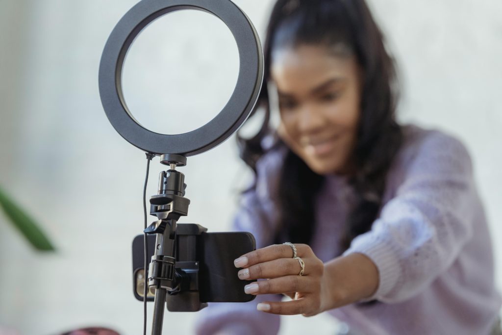 Overcoming the fear of posting online. Photo of a girl setting up her phone to record.