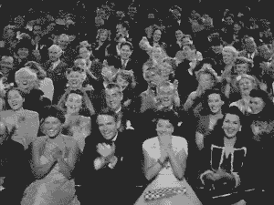 Your audience isn't lazy — your journey is too complicated. Black and white old school video of an audience clapping.