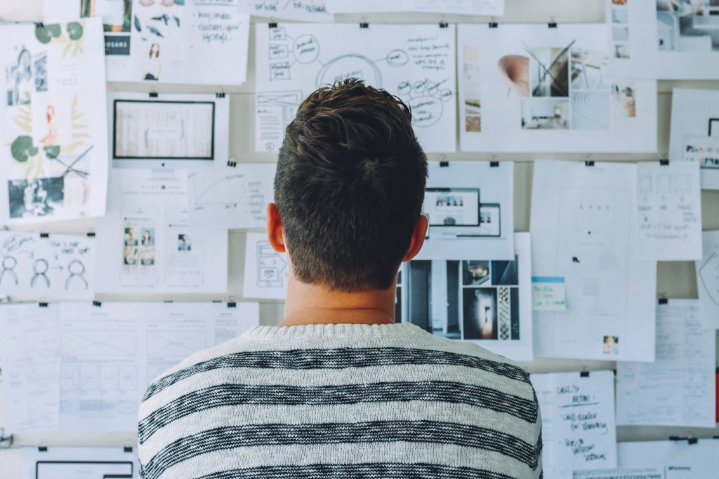 Man looking at a board full of ideas