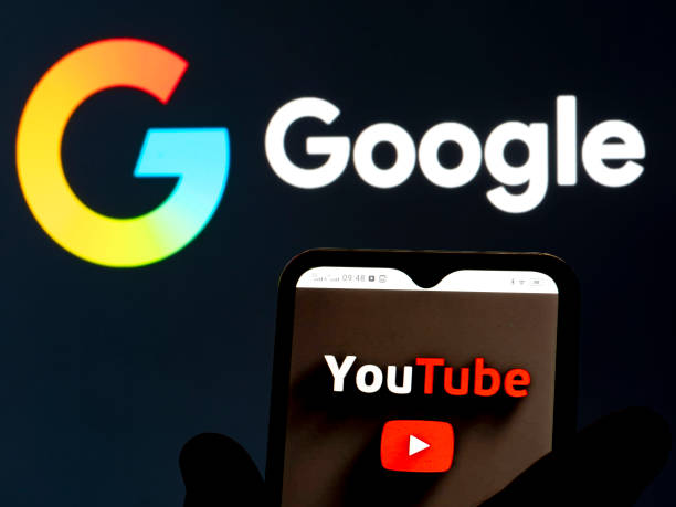 YouTube logo on smartphone. Background of image is Google logo