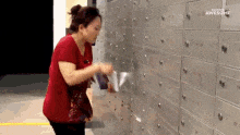 Lady posting mail into mail boxes really quickly GIF