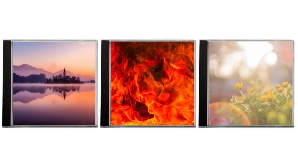 Three CDs with album covers. The first is a landscape, mountains over the water. The second is fire and the third is an out of focus lightburst with flowers.