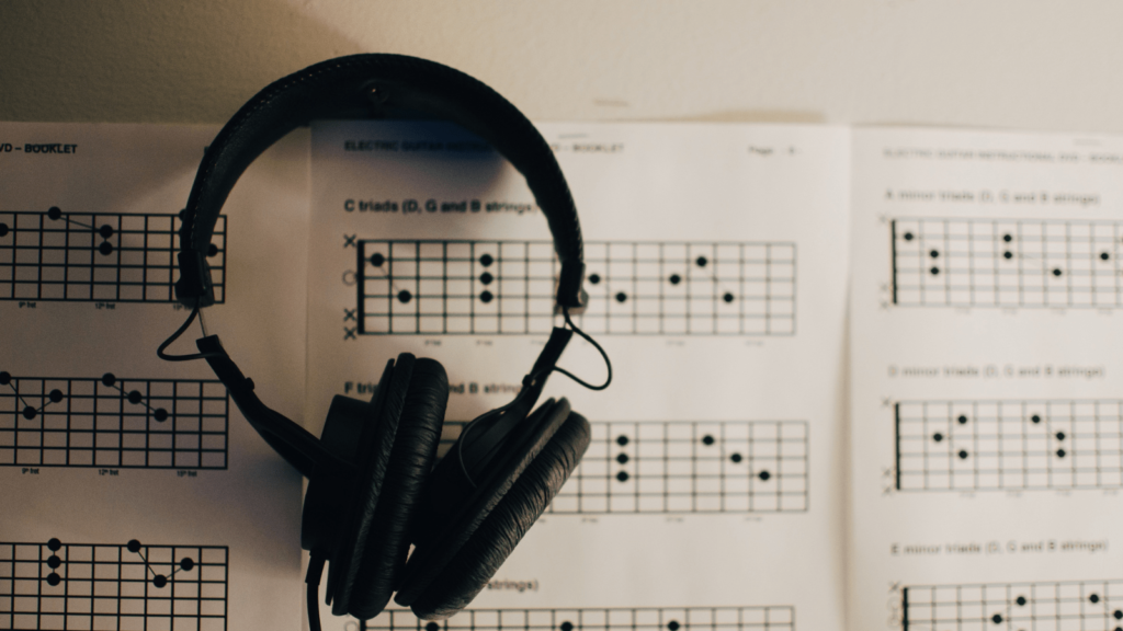 Music sheet with headphones sat on top
