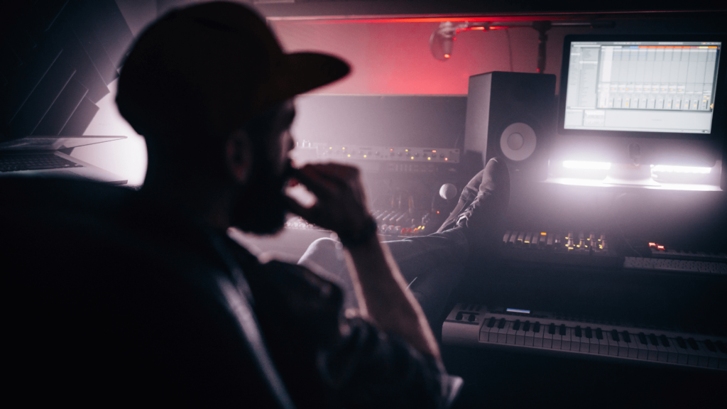 Music producer sat in front of equipment 