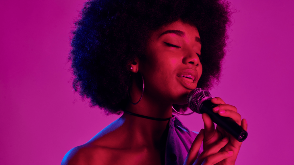 Singer against a purple background