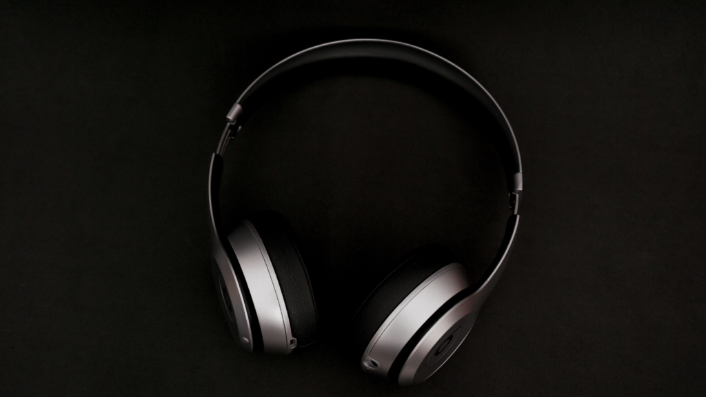 Black background with a pair of headphones in foreground
