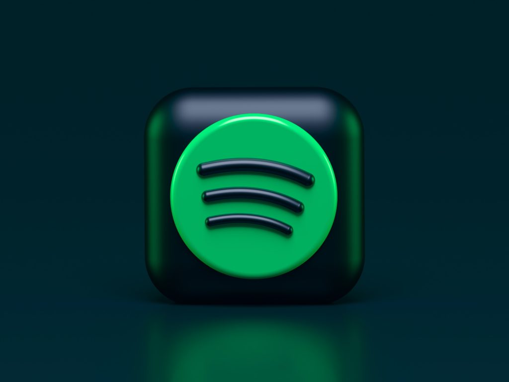 Black background, Spotify logo in the foreground with shadow. 
