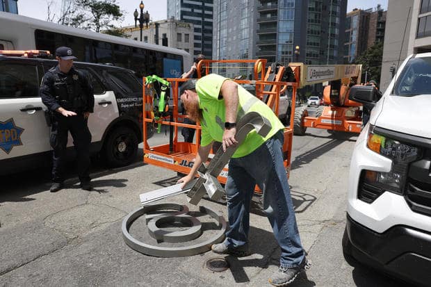 Workman removing previous Twitter logos.