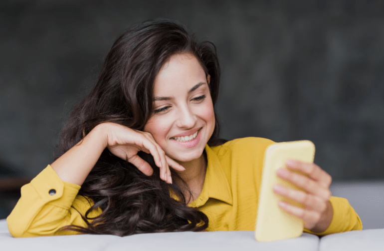 Girl smiling at her phone