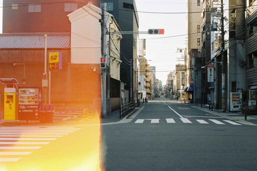 Has photography become too easy? Photo of a city, half is burnt from film and the other is in full colour.