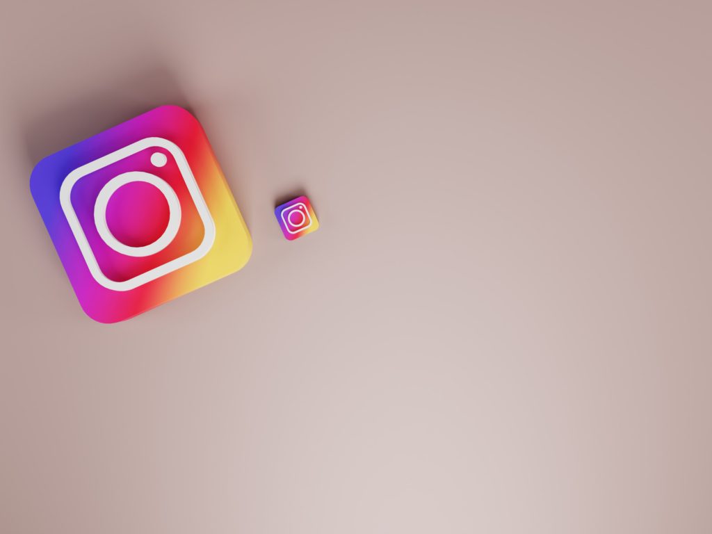 Using AI on Instagram - how to access artificial intelligence features. A grey background with one large Instagram icon and one small one.