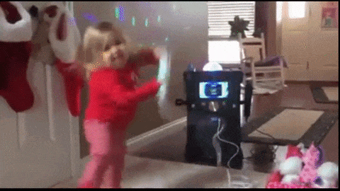 Jingle all the way - A simple guide to preparing your Christmas track. GIF of a girl dancing with a karaoke machine, surrounded by Christmas decorations. 