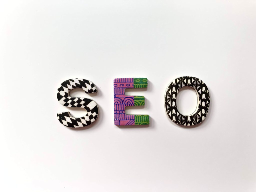 A Guide to (SEO) Search Engine Optimisation. Photo of SEO written out. Each letter has different patterns.