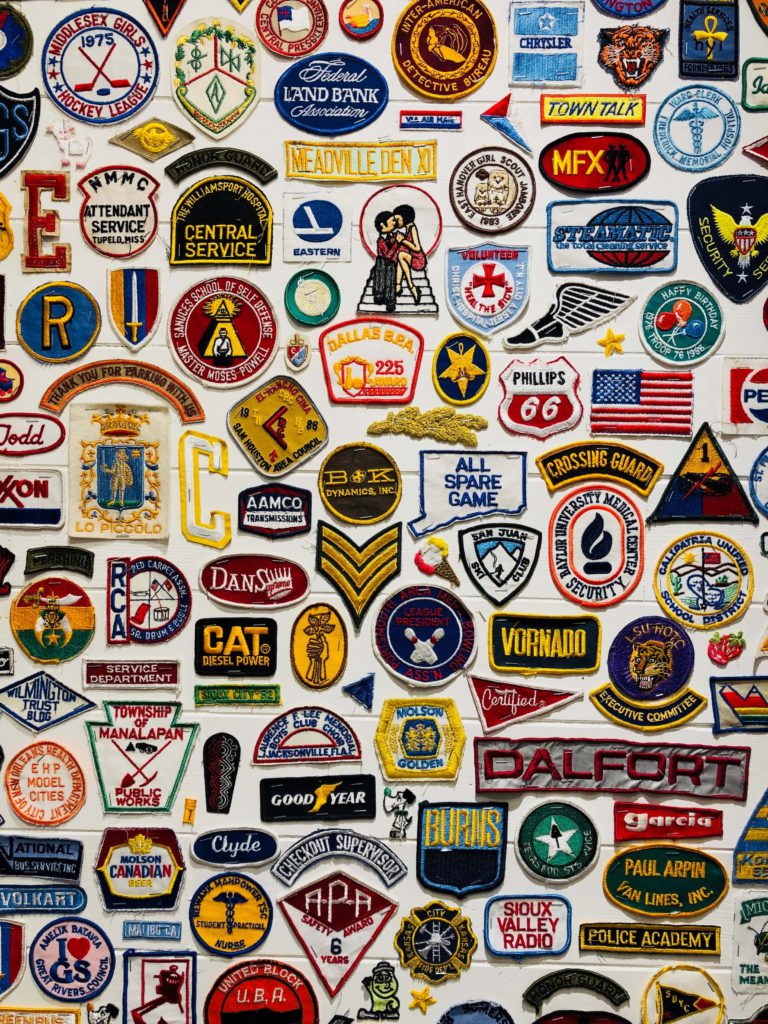A guide to choosing your dream brand name. Various brand logos on patches.