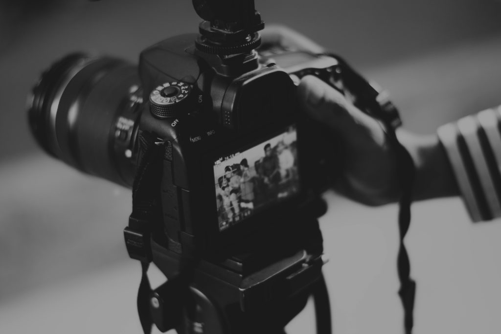 Do you need professional training to be a videographer, or can you thrive self-taught? Black and white photo of a camera videoing.