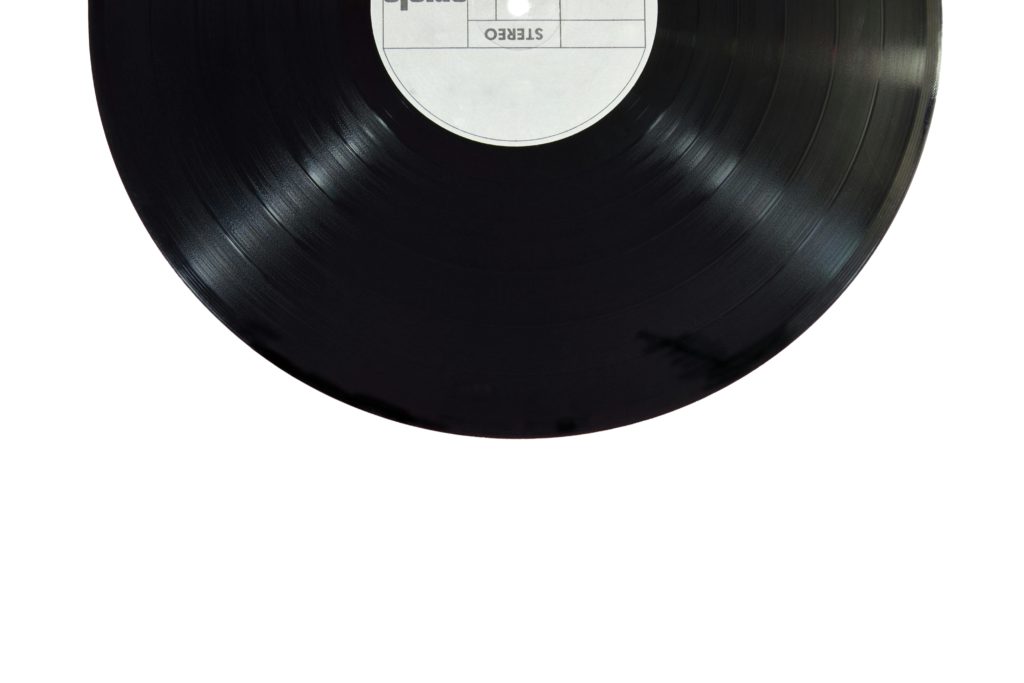 Music artists - how to increase your online presence. Half of a vinyl on a white background.