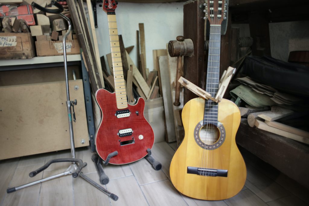 Electric vs. acoustic guitars - which should you choose? A photo of an electric guitar next to an acoustic one.
