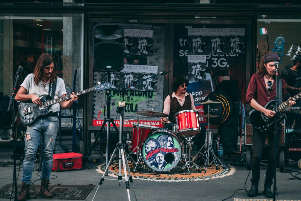 Band name inspiration - 20 different ideas. Photo of a rock band playing outside a shop.