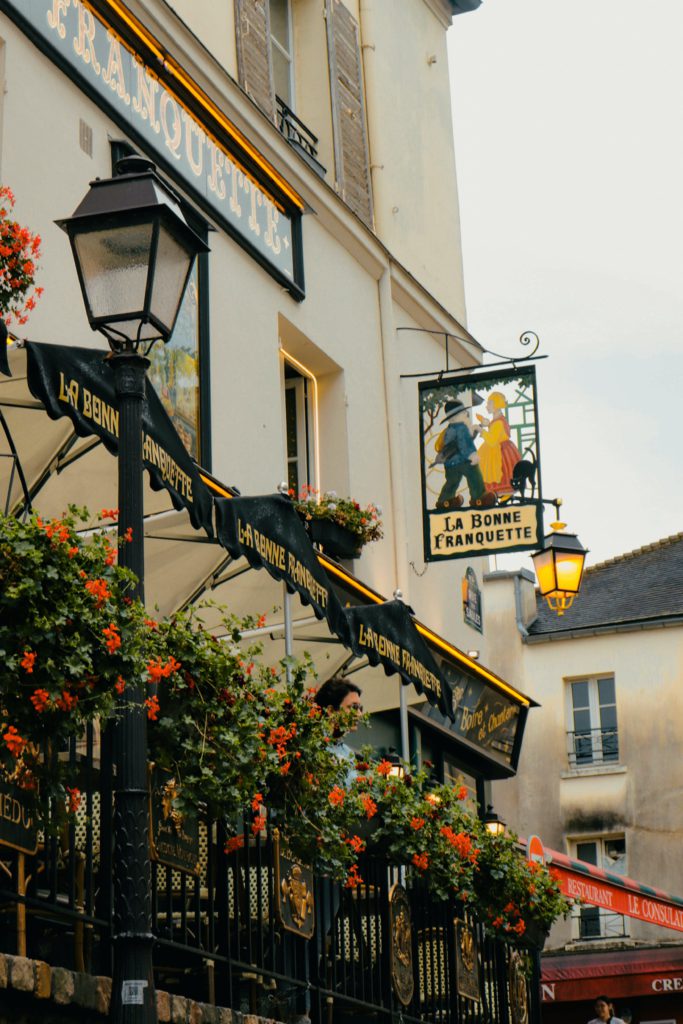 20 weird and wonderful business name ideas from ChatGPT. Photo of the front of a traditional looking pub where you can see flowers and the pub name.