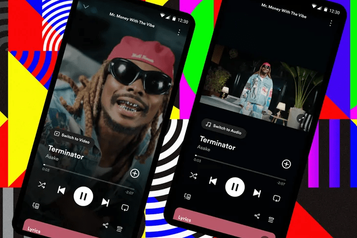 Spotify music videos are now in beta. Photo of two smartphones showing music videos on Spotify, against a funky background.