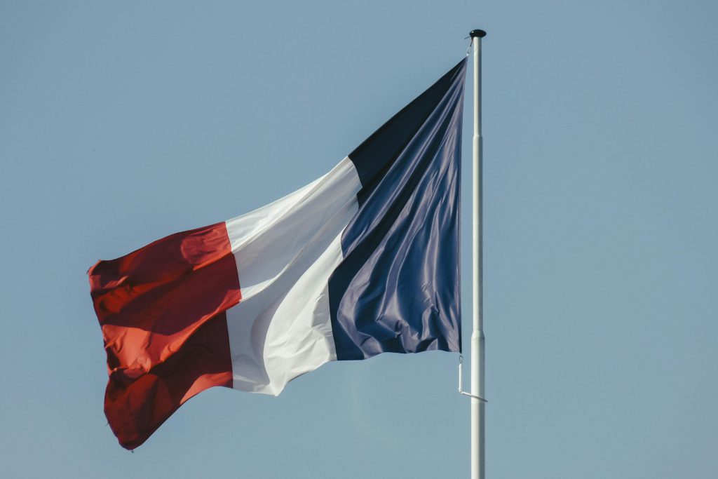 Spotify are increasing subscription costs for French users due to streaming store tax. Photo of a French flag.