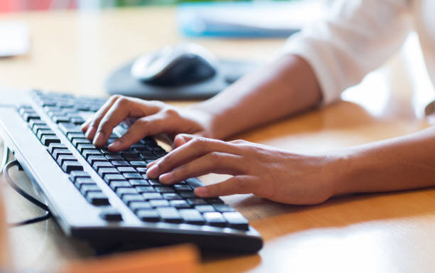 Boost your efficiency - essential keyboard shortcuts that save time. Photo of up close of someone typing on a computer keyboard.