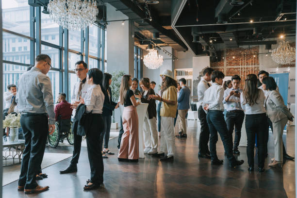 Tips for planning memorable events - a simple guide. Photo of lots of people in a building all talking.