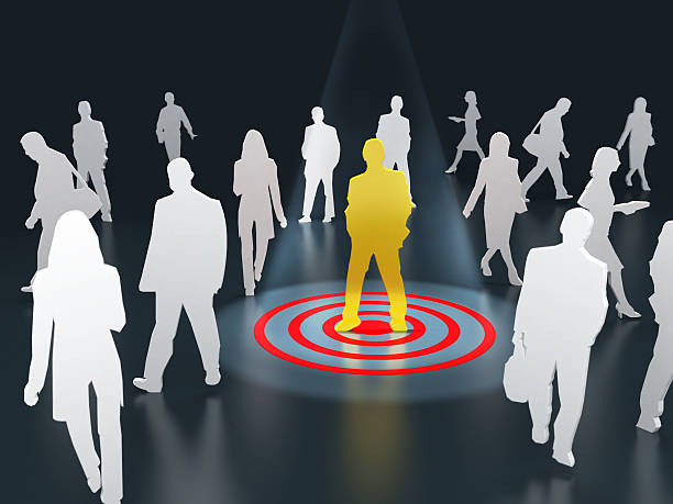 Using paid advertising to promote your music. Graphics of multiple silhouettes 'audience' and one person stood in the middle in yellow with a target under their feet.