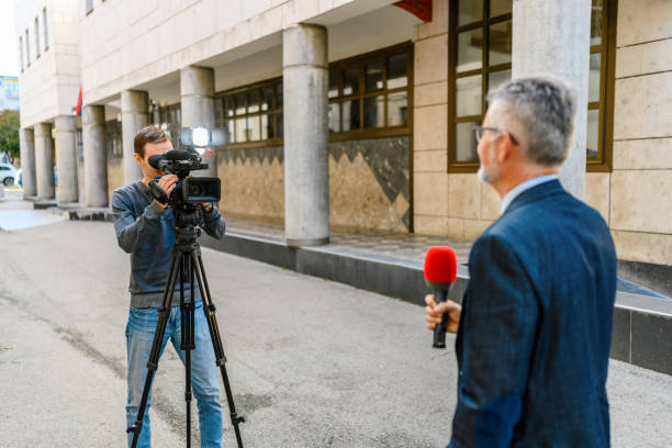 Crafting the perfect press kit for your music. Photo of someone recording a male with a microphone in a reporter setting.