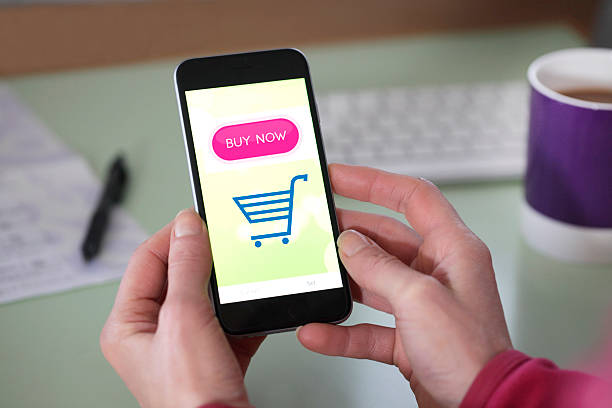 6 useful tips for Etsy sellers. Photo of someone holding a smartphone with a shopping cart on.