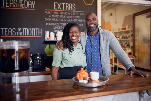 Tips for hiring the right employees for your small business. Photo of a couple in their independent tea shop.