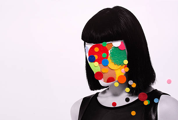 How to stay inspired as a long-term creator. Photo of a woman, but her face is covered with circles cut out of material. 