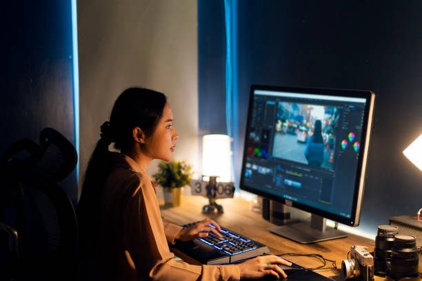 Simple photo editing tips for beginners. Photo of a woman sat at a desk editing photos on her computer.