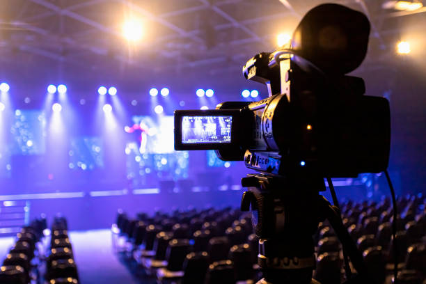 How to book independent music artists. Photo of a camera videoing an empty theatre.