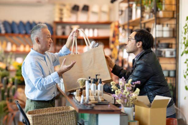 Effective upsell strategies to boost your revenue. Photo of a man selling products to another man with lots of upselling options.