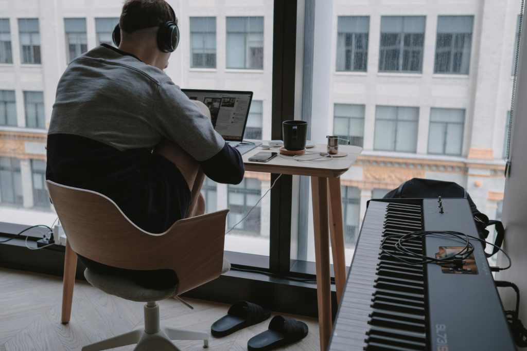 Why your desk setup matters for your health. photo of a man sat at a desk.