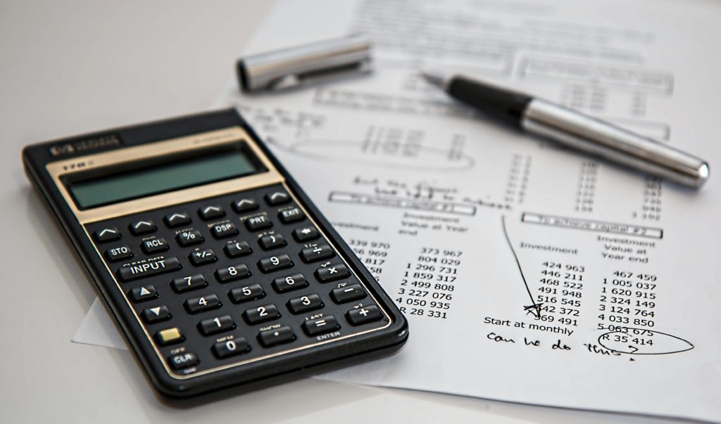 Do small business owners need an accountant? Photo of a calculator on a receipt with a pen.