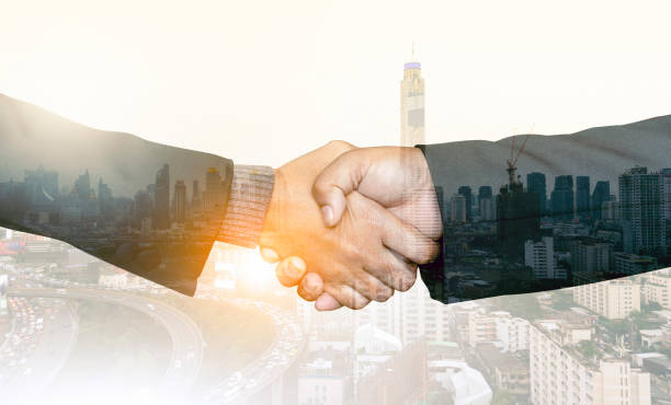 How to secure sponsors for your event. Photo of two hands shaking with a city overlaid.