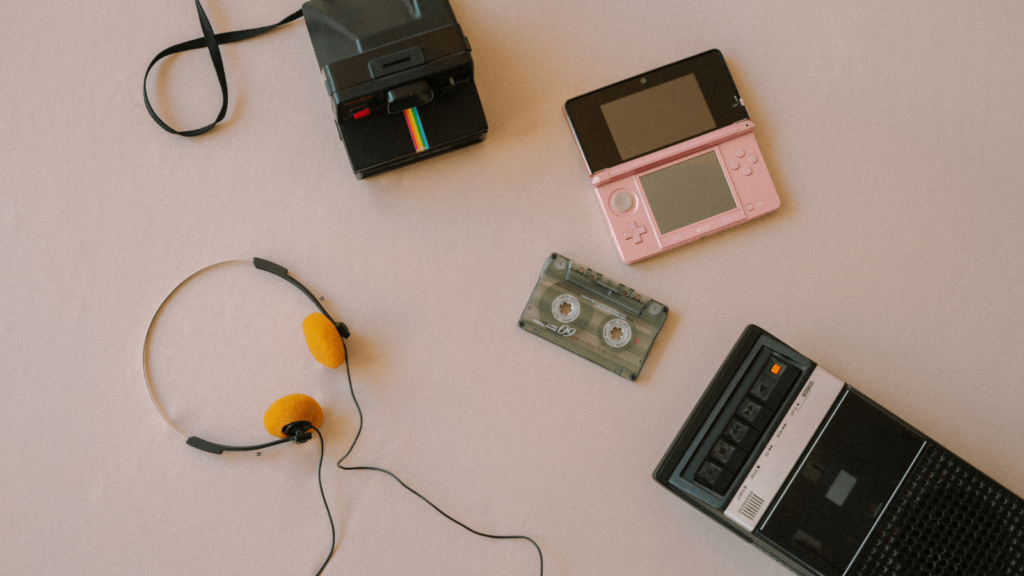 Why nostalgia is taking over music right now. Photo of retro camera, recorder, headphones, a cassette and a DS.