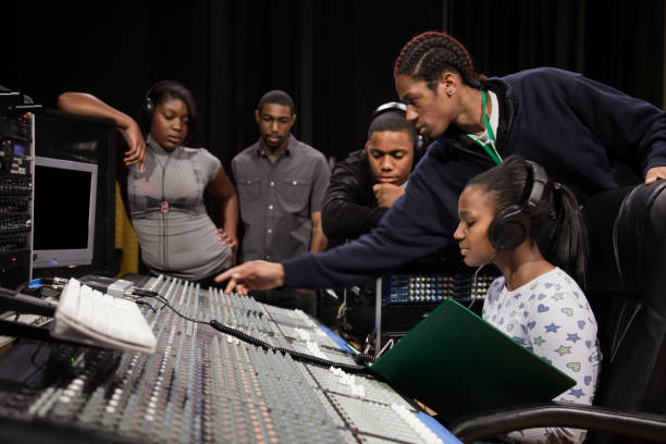 What is compression in music production? Photo of people creating music together.