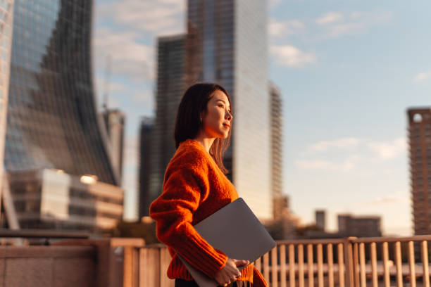 Do I need a business licence to sell digital products? Photo of a businesswoman surrounded by skyscrapers.
