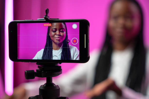 How to start creating content when you feel like you have nothing to say. Photo of a girl recording herself on her phone.