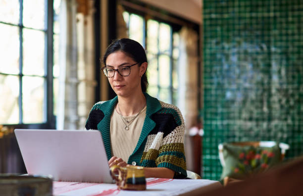 Top 5 SEO tools for small businesses. Photo of a woman at her laptop in a cafe.