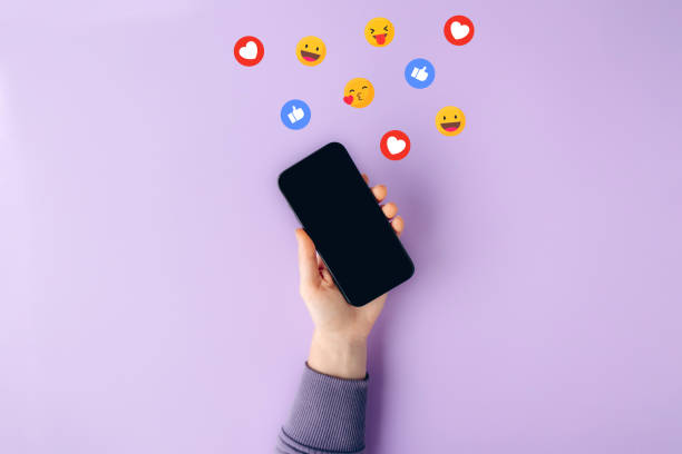 What’s the 80/20 rule for social media content? Purple background. Hand holding smartphone up, lots of emojis coming from the phone.