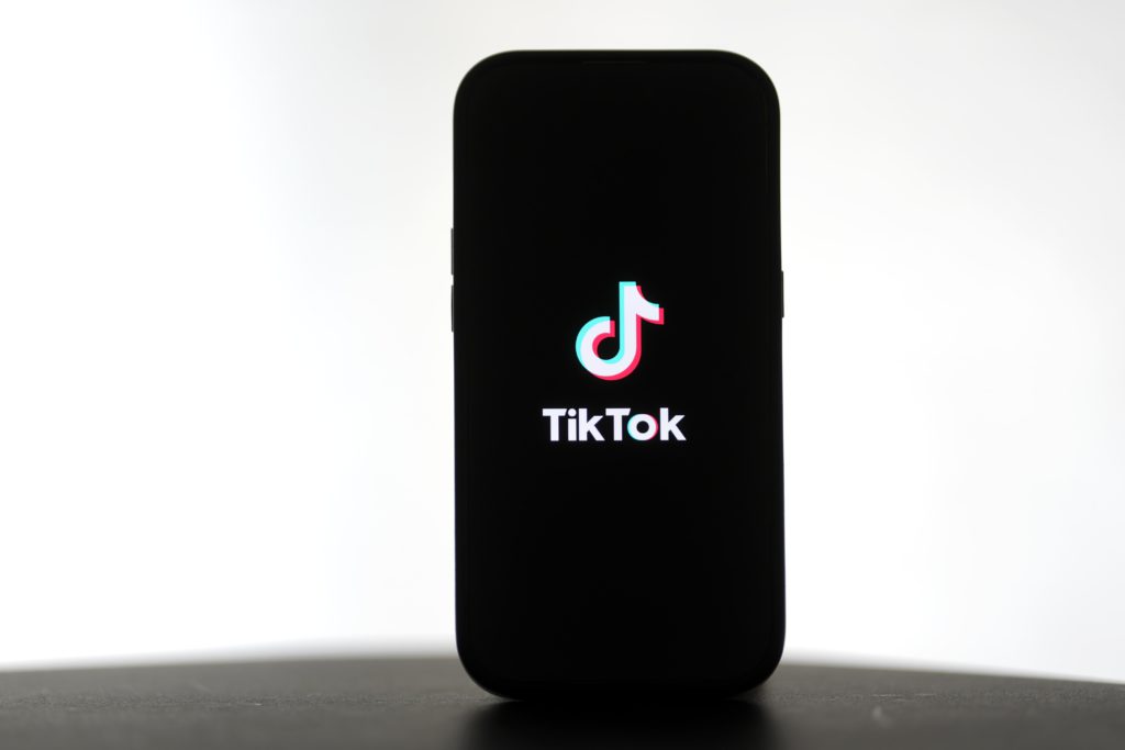 TikTok for Artists now available globally. Photo of the TikTok logo on a smartphone.