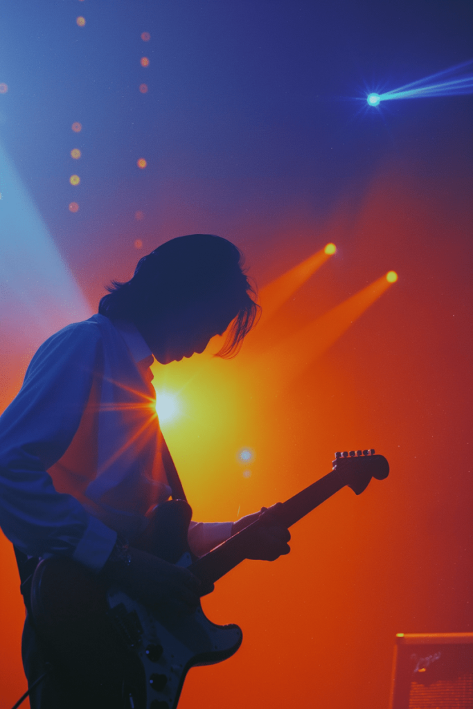 Discovery & algorithm bias: why good music often goes unheard. Photo of a guitarist with lighting on stage.