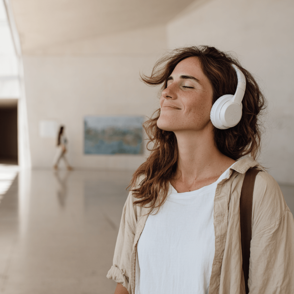 How to create a release plan that gets your music heard. Photo of a woman listening to music through headphones.