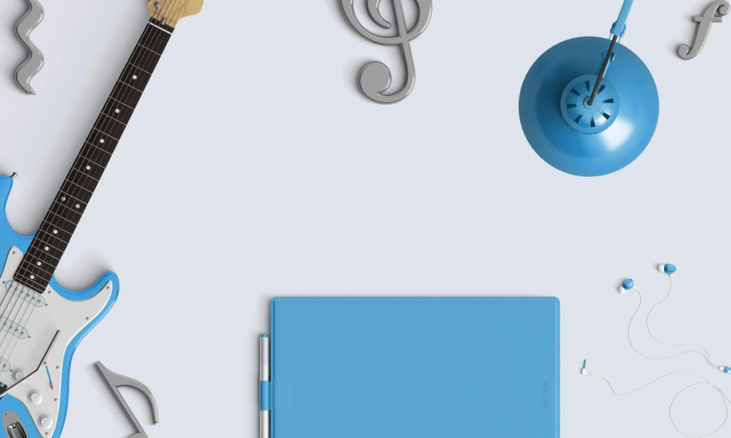 What’s the easiest instrument to learn by yourself? Photo of a guitar, along with musical symbols.