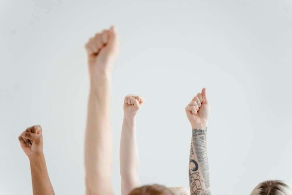 Why registering with a performing rights organisation (PRO) matters. Photo of arms in the air.